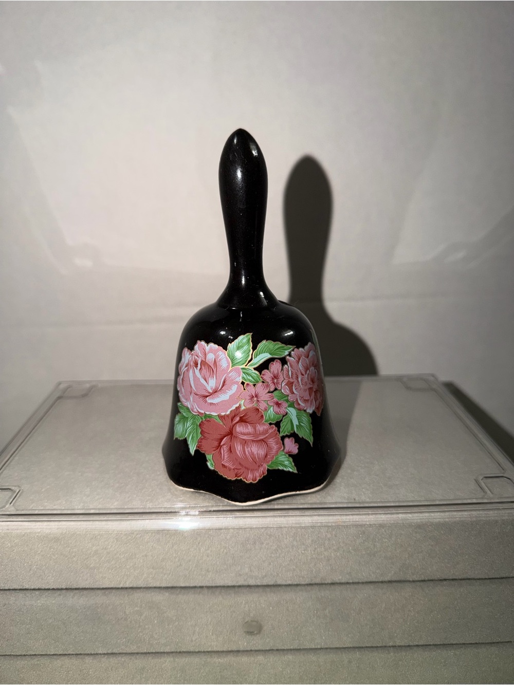 Black Handheld Decorative Bell with Pink Rose Floral Design